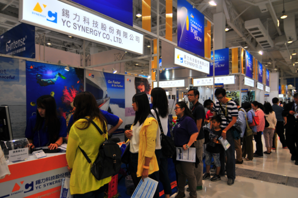 Visitors stand in a long queue for a free ride on an all-electric yacht powered by YC Synergy's fuel cell technology